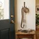 Pet ownership health research illustrated by a dog leash and collar hanging on a hook beside a stethoscope on an entry table