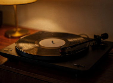 Phoebe Bridgers Lost Weekend concept: a vinyl record spinning on a turntable in warm lamplight