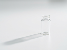 HHS vaccine recommendations concept, single glass vial on a sterile white surface