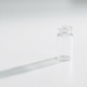 HHS vaccine recommendations concept, single glass vial on a sterile white surface
