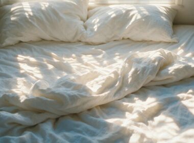 Sleep sweet spot study concept, overhead of rumpled white linen in morning sunlight