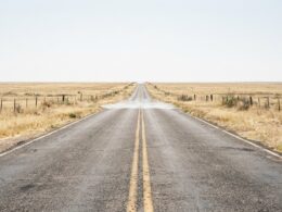 Southern Plains heat dome concept, empty Texas two lane road dissolving into heat mirage