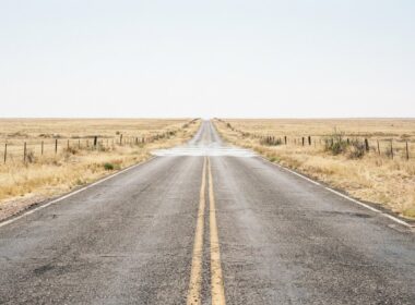 Southern Plains heat dome concept, empty Texas two lane road dissolving into heat mirage