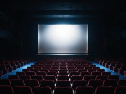 Spider-Man Brand New Day box office run, empty cinema auditorium with glowing screen