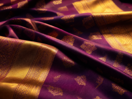 Thai textiles concept: draped handwoven silk with gold-threaded patterns in warm light