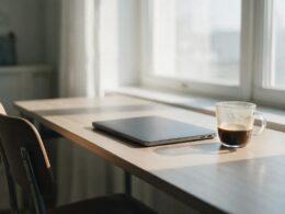 USDA telework ruling concept, empty home office desk with a closed laptop and cold coffee