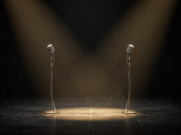 Verzuz Donell Jones vs Joe, two vintage microphones facing each other on a dark stage