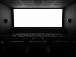 You Maniac series concept: empty cinema seats facing a bright glowing screen